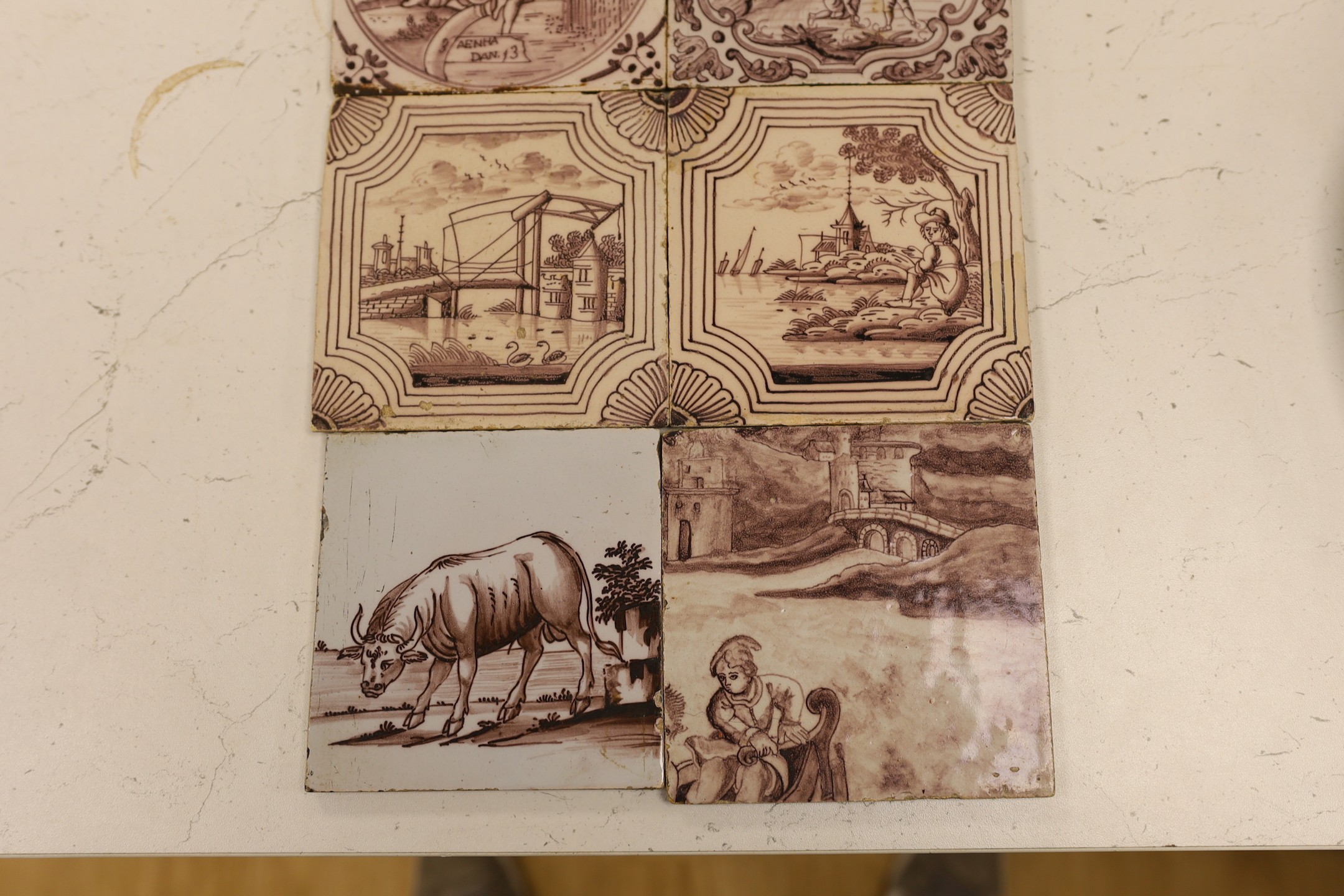 Six Delft manganese tiles, 18th century, each decorated with figures or animals in landscapes, five 12.5 cm